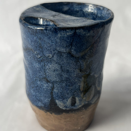 Blue and Brown Handle less ceramic tumbler with a partial lid
