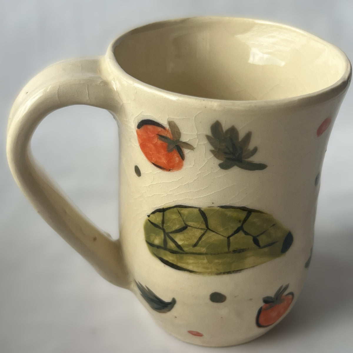 White Ceramic Mug with a drawing of a turtle eating a cherry tomato design