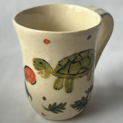 White Ceramic Mug with a drawing of a turtle eating a cherry tomato design
