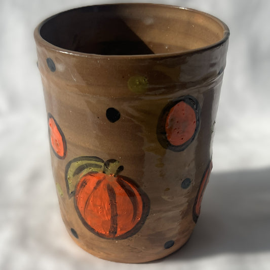 Handle less brown ceramic tumbler with Drawn pumpkin Design