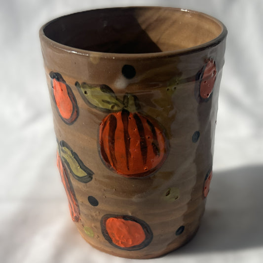 Handle less brown ceramic tumbler with Drawn pumpkin Design